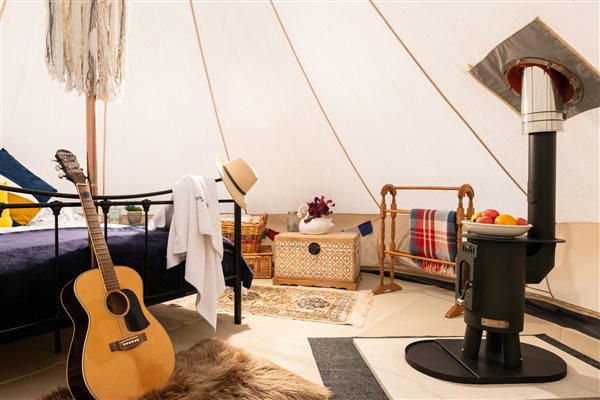 Log burner inside bell tent to stay cosy and warm